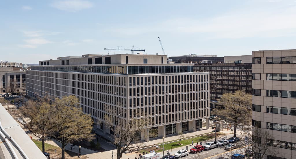 Aerial view of the Lyndon Baines Johnson Department of Education Building in Washington, D.C., surrounded by trees and neighboring offices